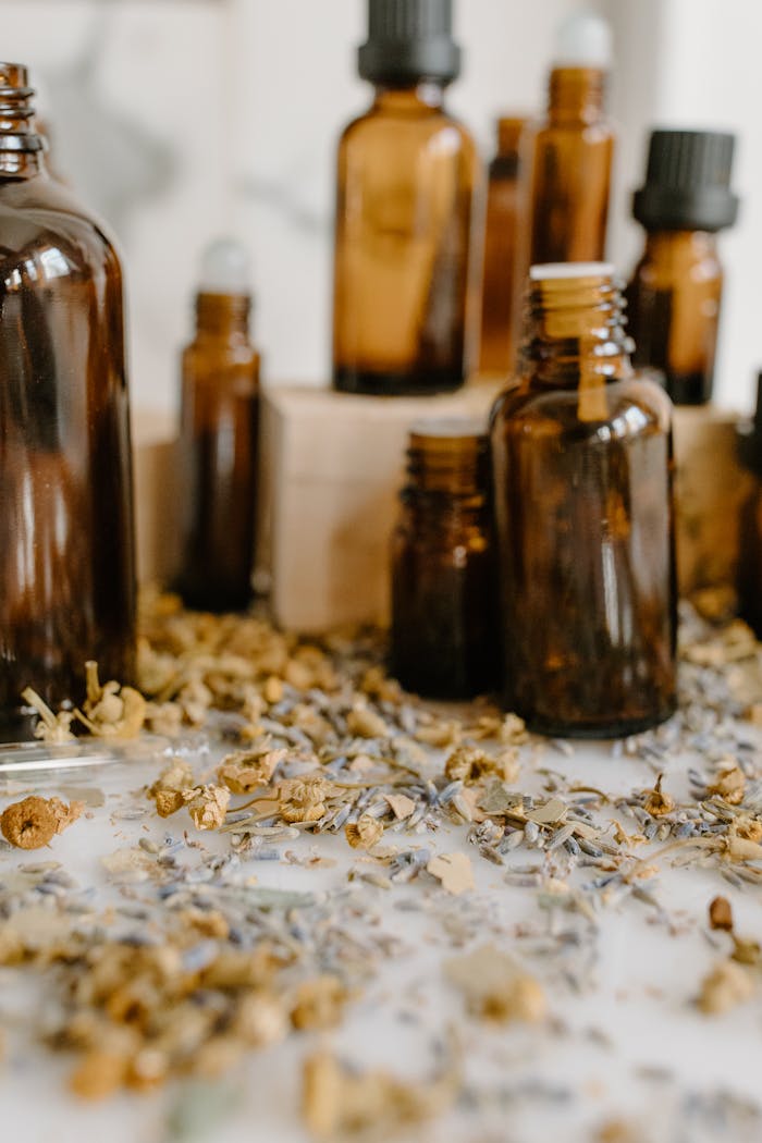 Aromatic herbal essential oils with chamomile and lavender on a white surface.
