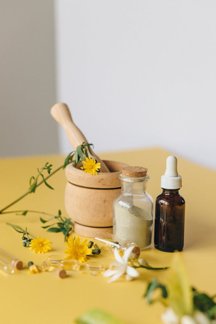 pexels photo 7526062 Aromatic herbs with mortar, pestle, and bottles for natural medicine concept.